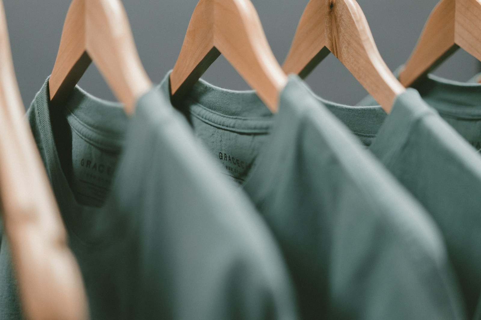 Close view of premium knitted tops on wooden hangers